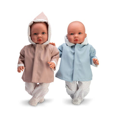 Two ASI Dolls, one in a brown raincoat, the other in a blue raincoat, standing side by side.