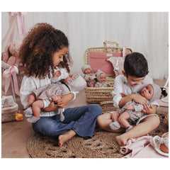 Children playing with ASI Dolls from the Leo Romper Martina Collection, showcasing stylish outfits and expressive eyes.