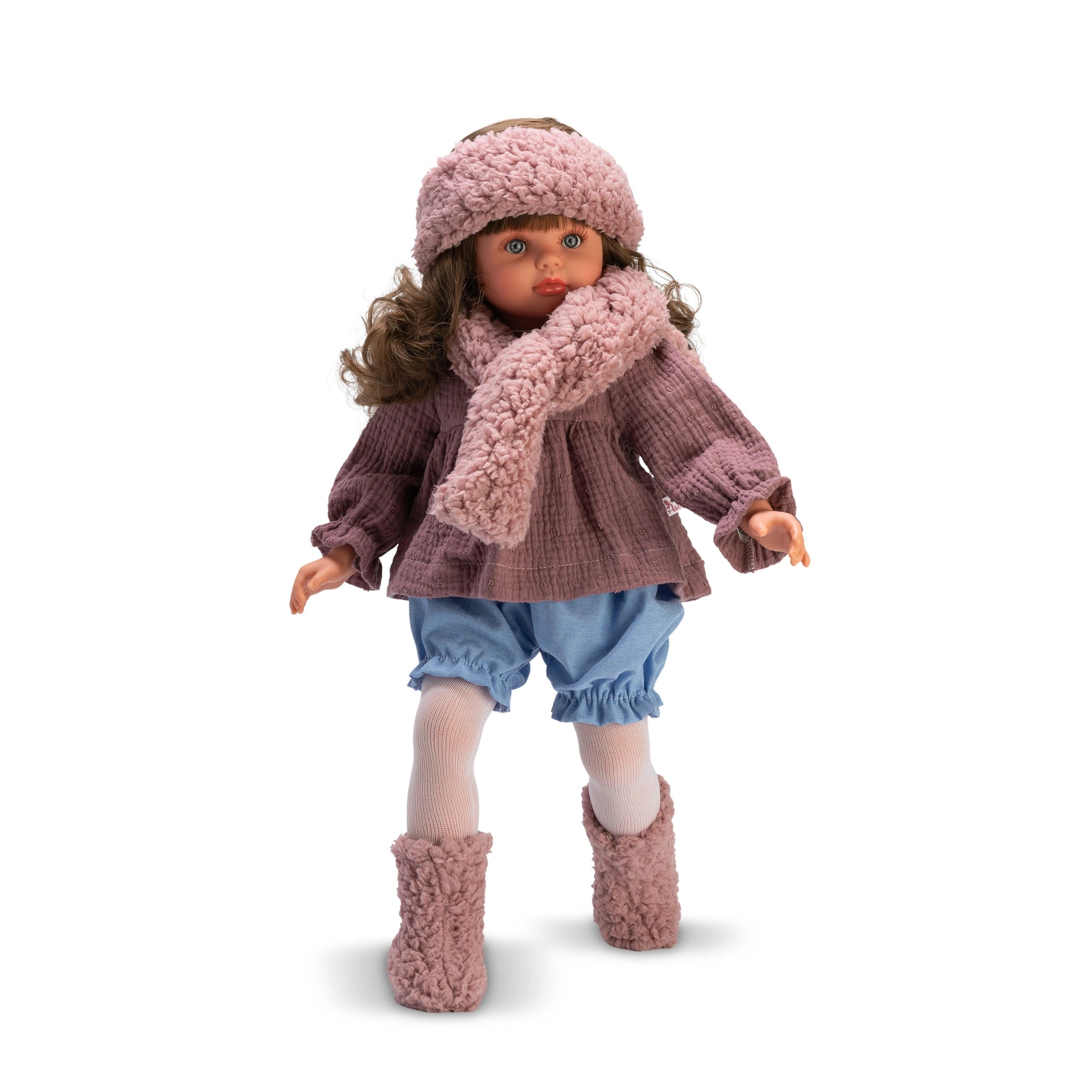 Pepa doll in a pink top, scarf, and hat, with blue denim shorts and pink boots, standing with curly hair and expressive eyes.