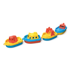Four colorful plastic boats, red and yellow, in a line; ferry, passenger, tugboat, cargo ship.