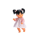 Cheni doll with black pigtails, wearing a printed dress and pink jacket, designed by ASI for imaginative play.