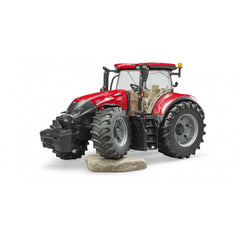 Red Bruder Case IH Optum 300 CVX toy tractor on a rock, showcasing large wheels and detailed cabin, 1:16 scale model.