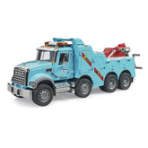 Blue Bruder MACK Granite recovery truck with light and sound features, six wheels, and red towing equipment.