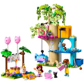 Colorful LEGO set featuring a tree house with a cat theme, birthday decorations, two minidolls, and playful cat figures.
