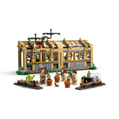 LEGO Hogwarts™ Castle Herbology Class set featuring a greenhouse, three minifigures tending magical plants in pots, and gardening tools.