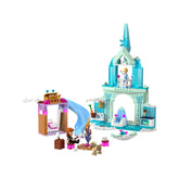 Elsa's Frozen Castle LEGO set showcases a turquoise and white palace with a slide, campfire, and colorful characters. Anna sits by the fire, while Elsa waves from the castle balcony. A playful dog and vibrant accessories enhance the magical scene.
