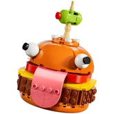 LEGO Fortnite Durrr Burger construction set featuring an orange burger with large eyes, a pink tongue, and a green olive on top.