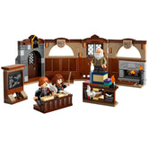 Hogwarts Charms Class LEGO set featuring two students at desks, a teacher with a wand, a chalkboard, and a cozy fireplace, all in intricate detail.