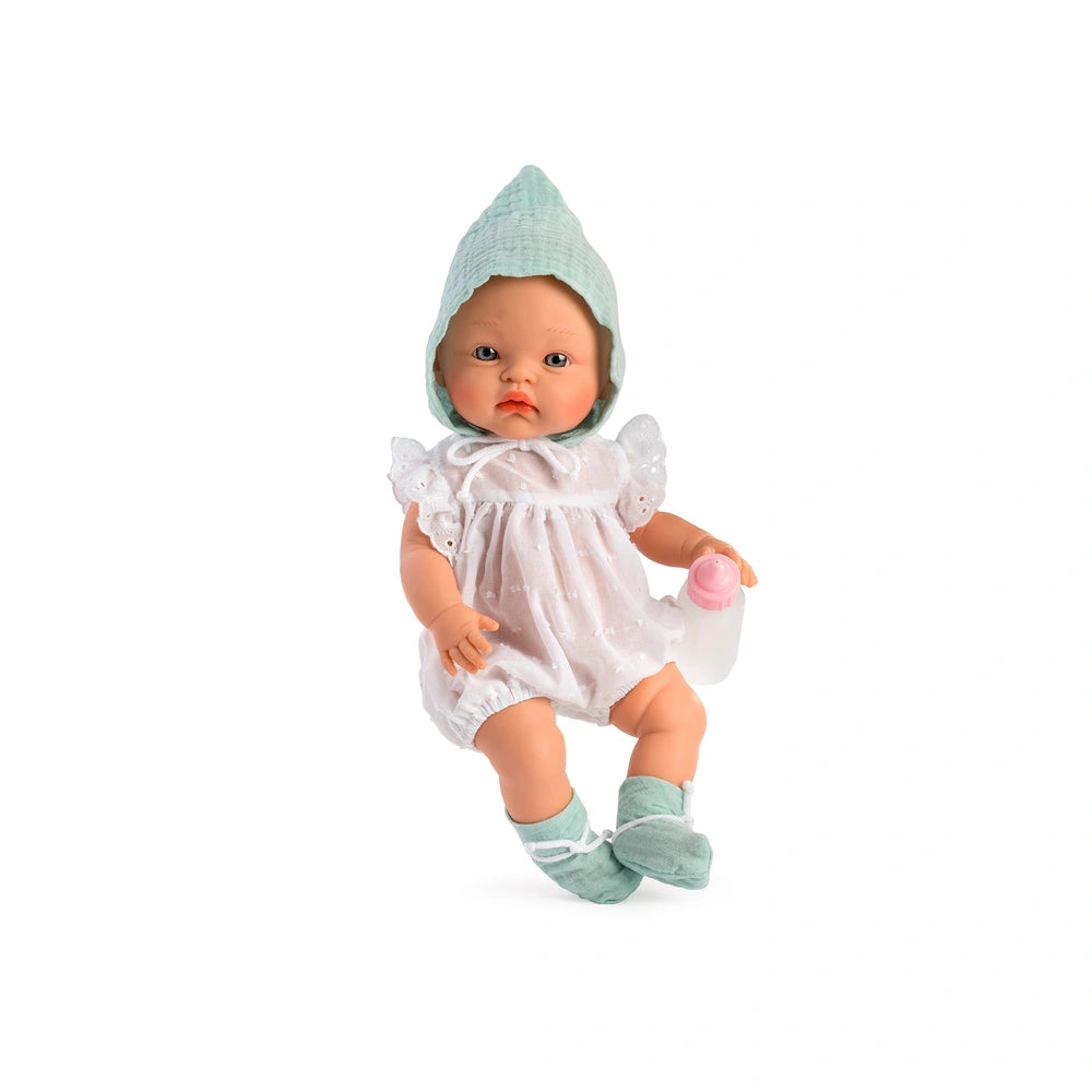 Alex doll with mint green hat, holding a pink bottle, in a white romper and matching socks, sitting on a white background.
