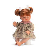 Guille Doll with red pigtails, floral dress, pink collar, sitting position, showcasing detailed and lifelike features.