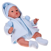 ASI Dolls Koke 36 cm wearing a soft blue outfit and hat with pom-poms, realistic features, lying on a white background.