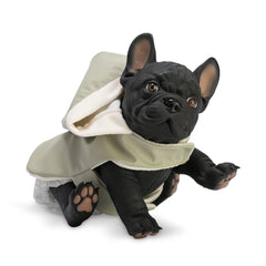 French Bulldog doll wearing a green raincoat, sitting with one paw raised.