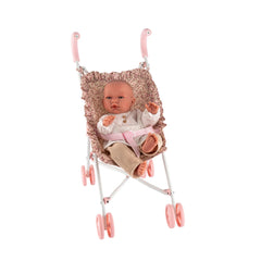 Doll in a pink floral stroller with beige fabric, secured by a pink strap, on a white background.