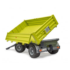 Green Bruder Fliegl Three-Way Dumper with raised bed, showcasing realistic wheels and removable top, in a bright studio setting.