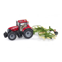 Red toy tractor with a green Krone dual rotary windrower attachment, showcasing realistic farm equipment design.