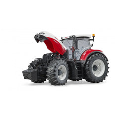 Red and white Bruder Steyr 6300 Terrus CVT toy tractor with open hood, large tires, and detailed cabin.