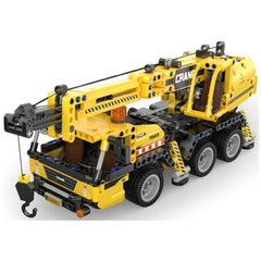 CaDA Mobile Crane Truck construction set in yellow with black wheels, orange rear lights, and visible components like a crane