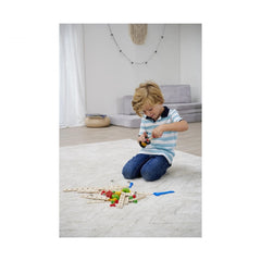Eichhorn Constructor Expansion Set with 75 colorful pieces is being explored by a focused child on a carpeted floor.