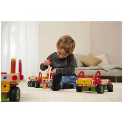 Eichhorn Constructor Truck set with 135 pieces is being played with by a child sitting on a white carpet indoors.
