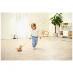 Eichhorn Pull-along Animal Duck with child on wooden floor, holding leash, in a cozy indoor setting with neutral colors.
