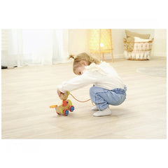 Eichhorn Pull-along Animal Duck toy with a child interacting in a cozy, light-filled room setting.