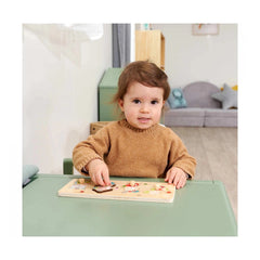 Eichhorn Puzzle Friends featuring a young child playing at a light green table in a cozy indoor environment.