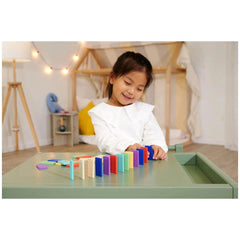 Eichhorn - Wooden Domino Ralley baby activity toy set engages a girl in colorful building blocks playtime.