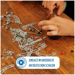 Eitech Rubin Rocket Racer Green construction set with metal, plastic components, and red washers on a wooden tabletop.