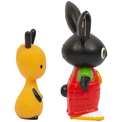 Bing Flop toy figurine features yellow and black colors, red shirt, green pants, white shoes, and a matte plastic finish.