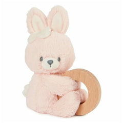 Gund Soft Animal Ring Rattle is a pink plush bunny with large ears and a bow, sitting on a smooth wooden surface.