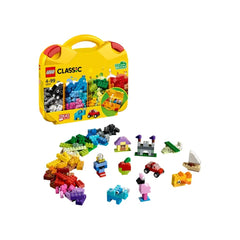 Colorful LEGO® bricks spread around a sturdy yellow Creative Suitcase, showcasing various built models like a car, house, and animals.
