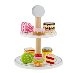 New Classic Toys cake stand set features a wooden base with a white top, displaying colorful plastic cupcakes with varied fro