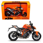 KTM 1290 Superduke R die cast motorcycle in orange and black displayed in an orange cardboard box with plastic window.