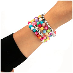 Colorful and silver beads arranged on black fabric for the Nice - Beads Abc Pcs 500 Fluo Set in arts and crafts.