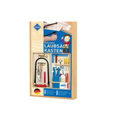 Wooden fretwork kit box with tools neatly organized inside, featuring saw frame, small files, and colorful handles on display.