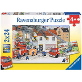 Ravensburger puzzle box features a vibrant fire scene with firefighters and fire trucks, showcasing colorful puzzle pieces in
