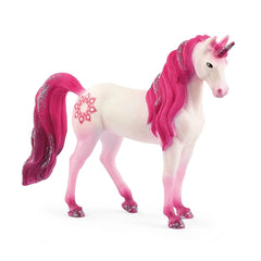 A white unicorn figurine with a vibrant pink mane and tail, featuring a decorative pattern, stands facing the viewer.
