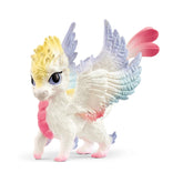 Rainbow Baby Dragon figure with colorful wings and a humanoid form, standing upright on a white surface.