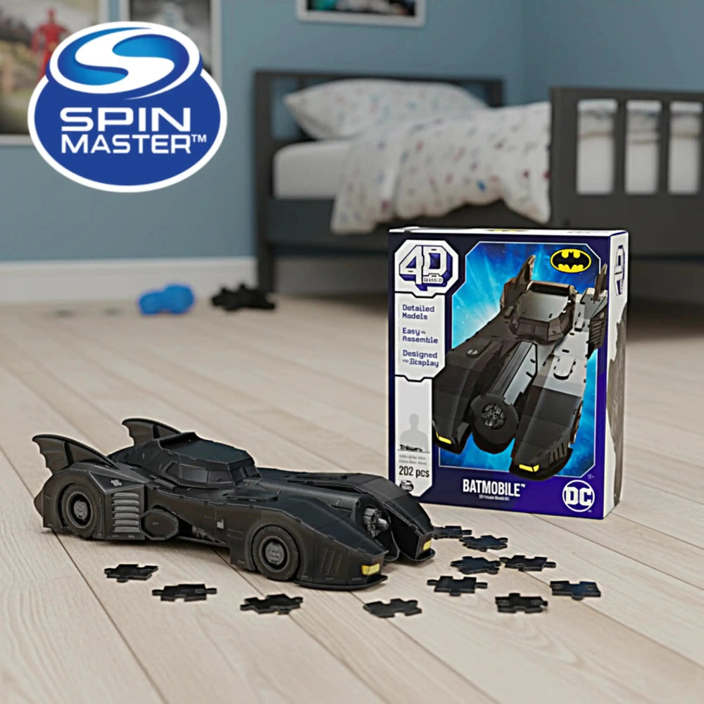4D Build DC Batman Retro Batmobile 3D Puzzle Model Kit displayed on a wooden floor next to its blue box featuring graphics an