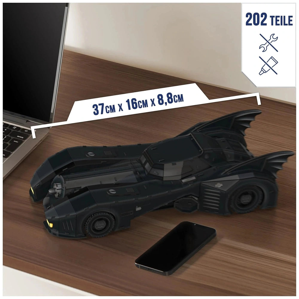 4D Build DC Batman Retro Batmobile 3D Puzzle Model Kit on a wooden surface, showcasing its sleek design and glossy black fini
