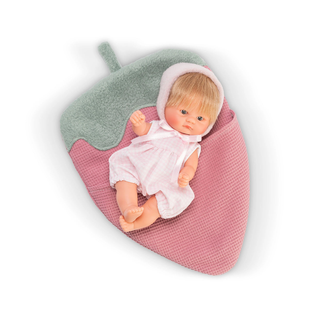 ASI Dolls - Lalka Bonboncin Strawberry Doll lying on a pink and green textured blanket, wearing a pink outfit.