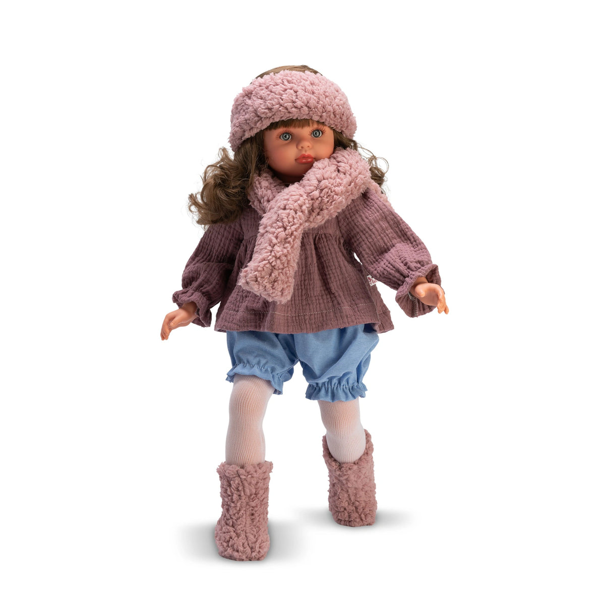 Pepa doll in a pink top, scarf, and hat, with blue denim shorts and pink boots, standing with curly hair and expressive eyes.