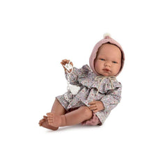 María doll wearing floral ruffle shirt and pink bloomers, holding a pacifier, lying down with a pink bonnet.