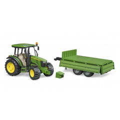 Green John Deere 5115M toy tractor with detachable tipping trailer and front weight on white background.