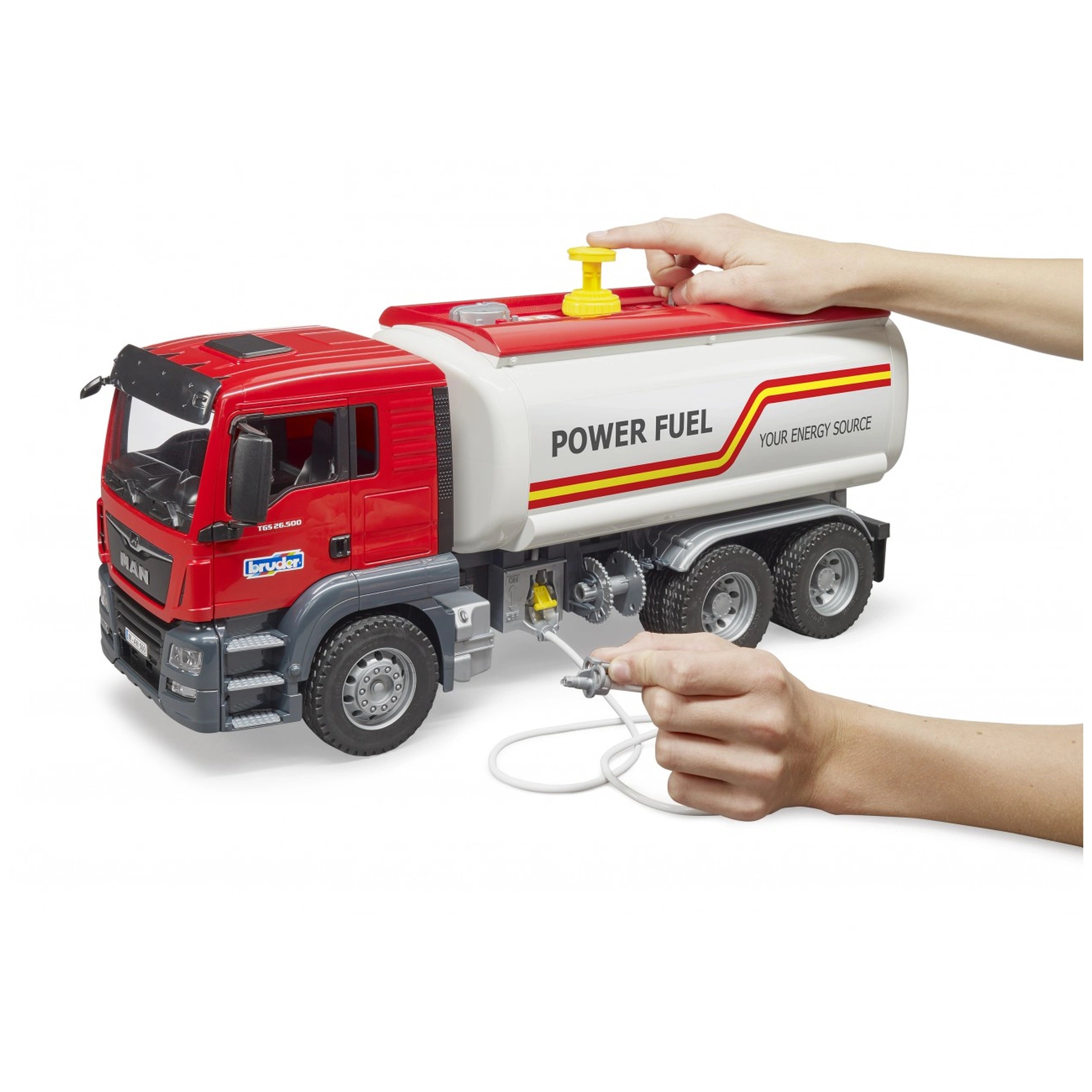 Red and white Bruder MAN TGS Tank Truck toy with hands operating the functional water tank and pump.