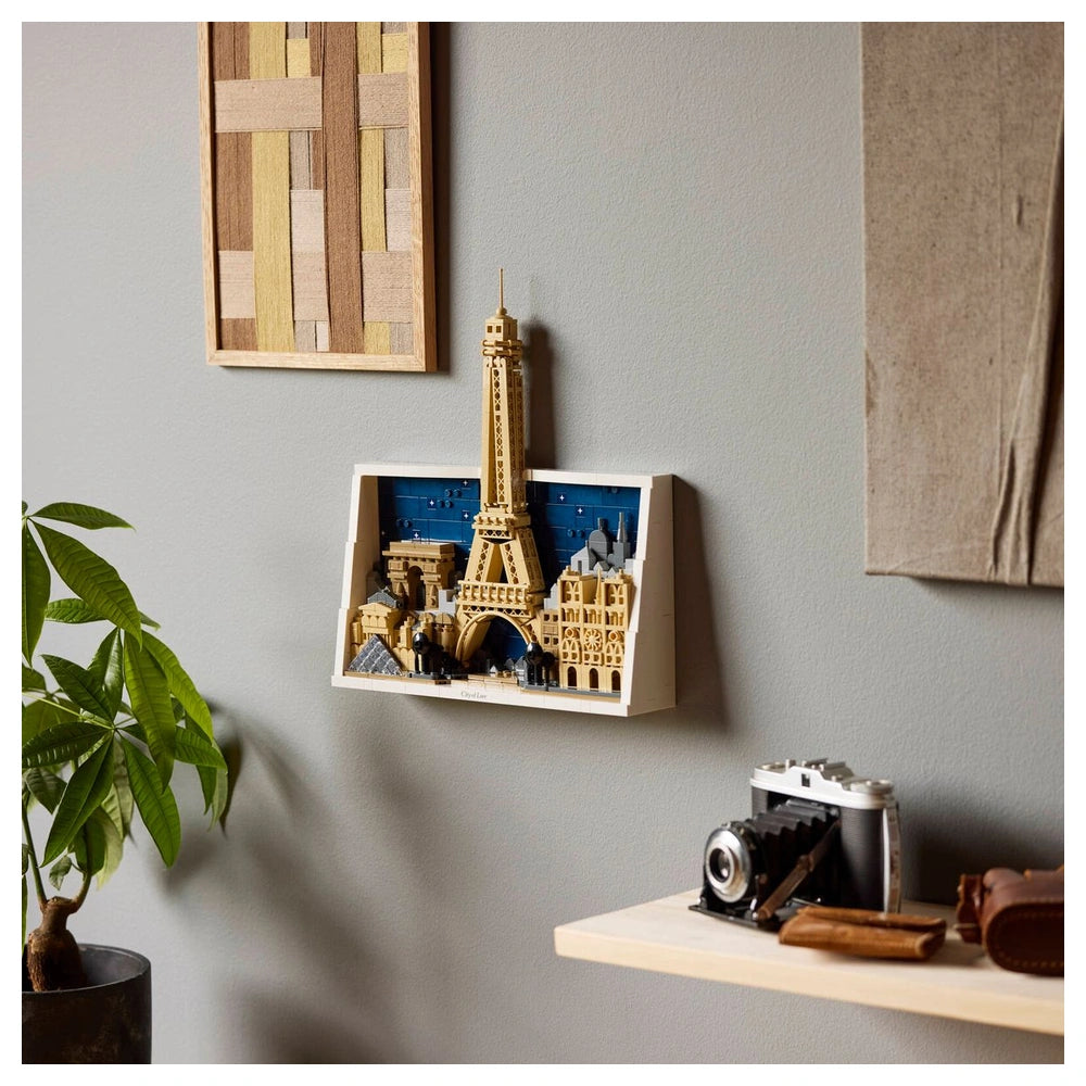 LEGO Architecture Paris construction set displayed on a wooden shelf with a plant and decorative art in a cozy indoor setting