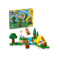 LEGO® Animal Crossing™ Bunnie's Outdoor Activities set features a colorful campsite scene with a buildable tent, trees, and playful accessories. The cheerful Bunnie minifigure holds a net and stands near a small stream, surrounded by vibrant greenery and flowers.