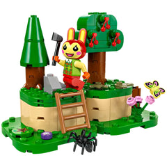 LEGO® Animal Crossing™ Bunnie minifigure holds a shovel, smiling on a grassy campsite with trees, flowers, and a spider.