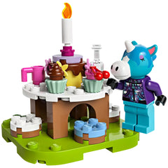 Colorful cake centerpiece with a lit candle, surrounded by cupcakes and a festive unicorn figure in a birthday celebration scene.