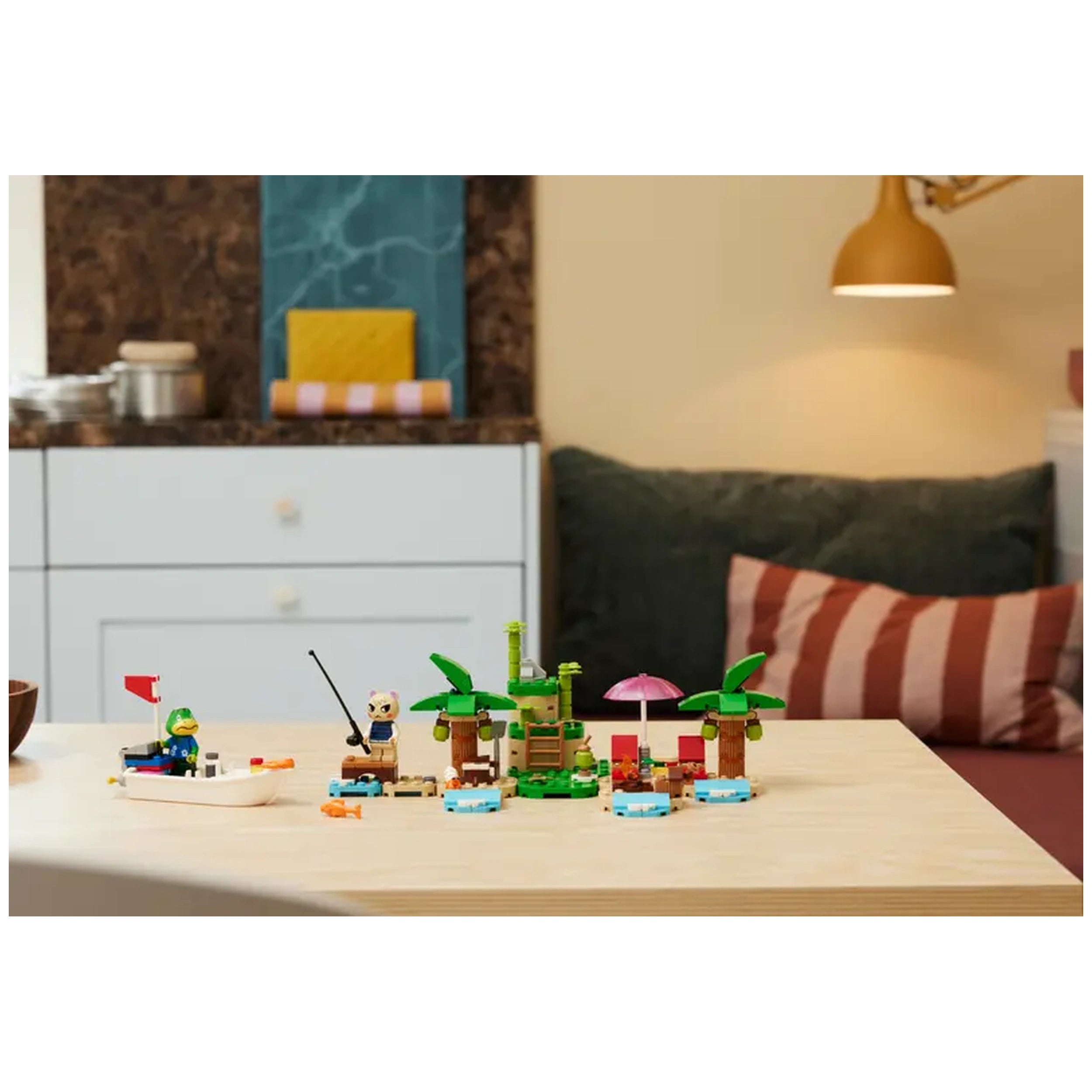 A vibrant LEGO® set depicting Kapp’n on a boat near a deserted island with palm trees, fishing gear, and a pink umbrella.